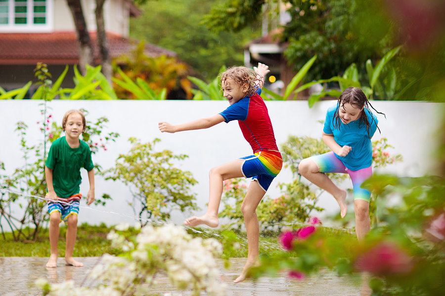 Kids Playing With Water Home in Summer Garden and Enjoying Outdoor Play