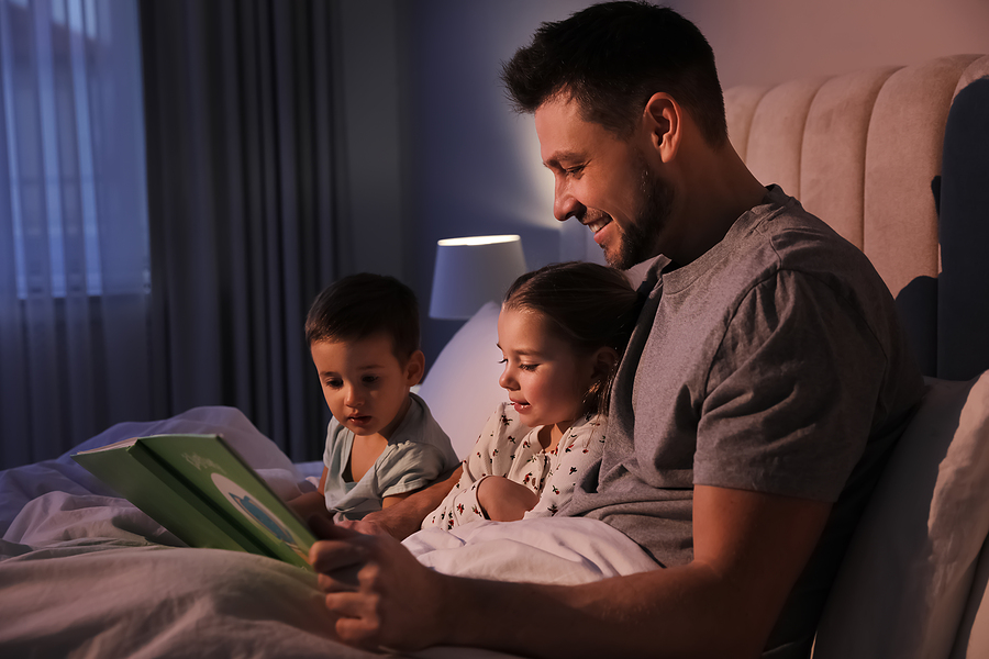 Father performing Bedtime Routines with Child while reading a Bedtime Story