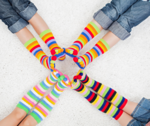Children with colored socks connecting feet
