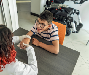 Occupational Therapist performing Occupational Therapy with a Young Boy