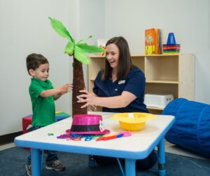 Brighton Center Teacher with Child Learning Behavior Reactions and Sensory Responses while Playing a Sensory Safe Activity
