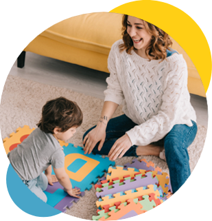 Mother Playing with Puzzle Pieces with Young Child