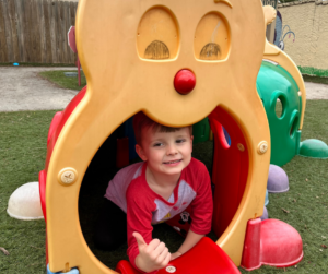 Brighton Center Student Safely Playing in the Playground